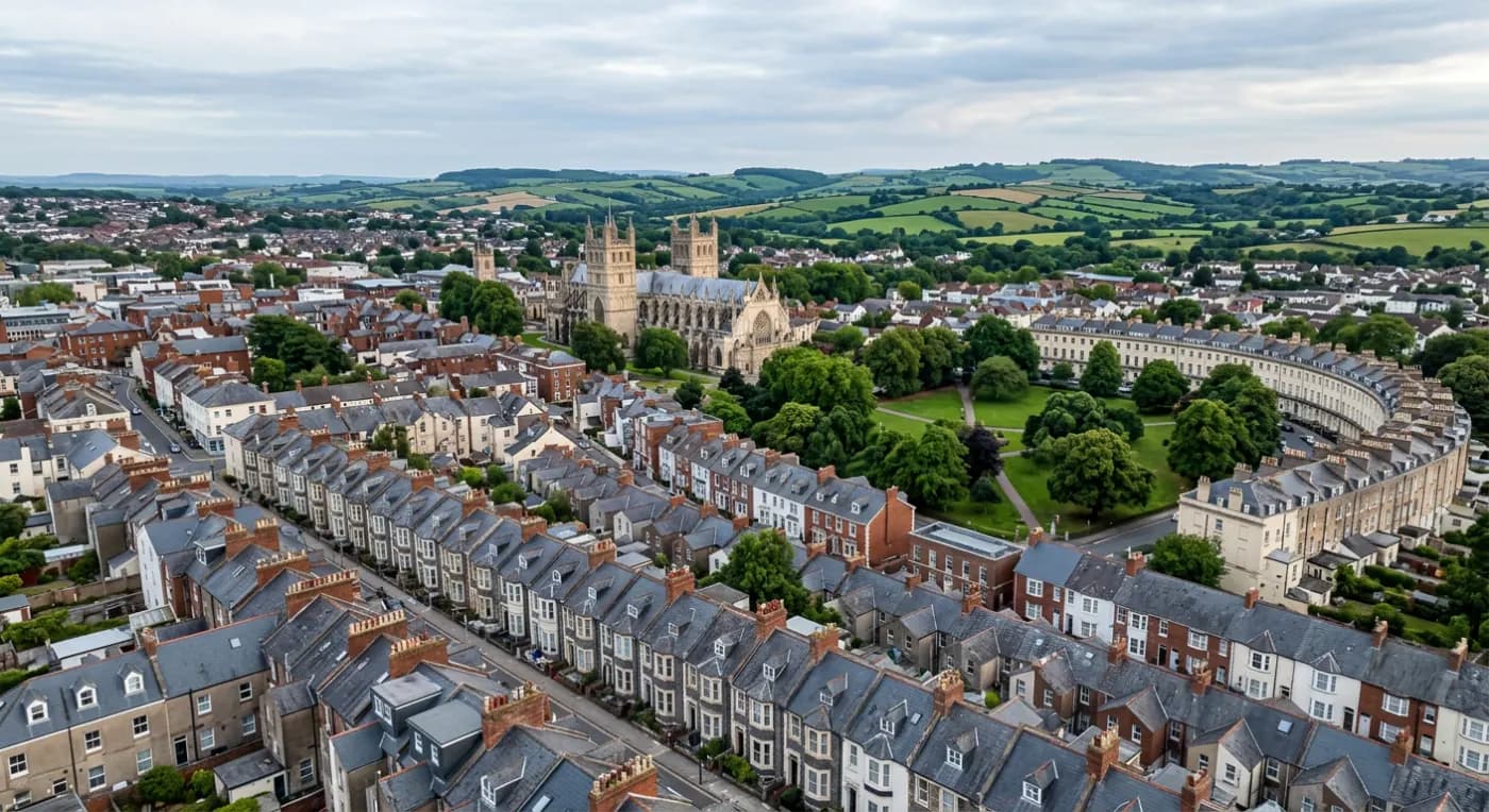 Aerial view over the slate rooftops and chimney stacks of a Devon city